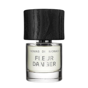 Thomas de Monaco - Fleur Danger zeigt minimalistischen Flakon mit schwarzem Holzdeckel und schlichtem Schriftzug auf klarem Glas