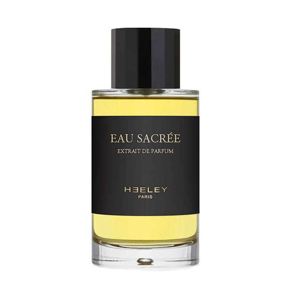 Heeley - Eau Sacrée - Extrait de Parfum Flakon mit schwarzem Etikett und goldgelber Duftessenz vor weißem Hintergrund