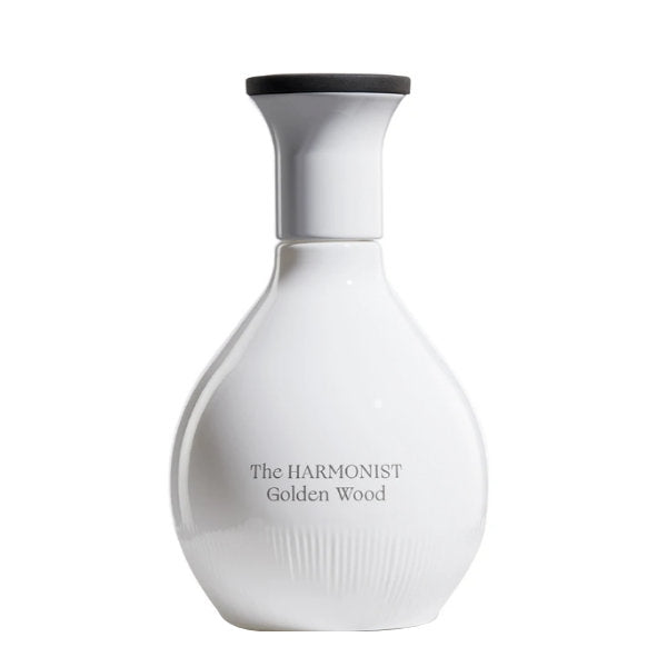 The Harmonist - Golden Wood Parfumflakon in schlichtem, weißem Design mit schwarzem Deckel vor weißem Hintergrund