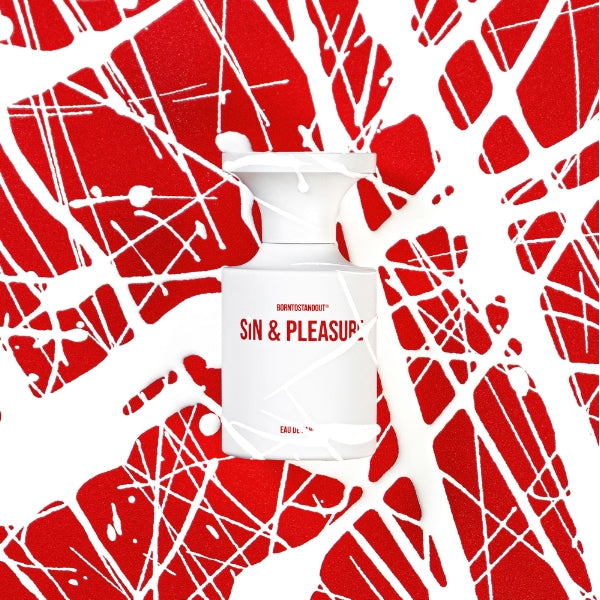 BORNTOSTANDOUT - Sin & Pleasure weißer Flakon mit rotem Schriftzug vor künstlerischem rot-weißem Splatter-Hintergrund
