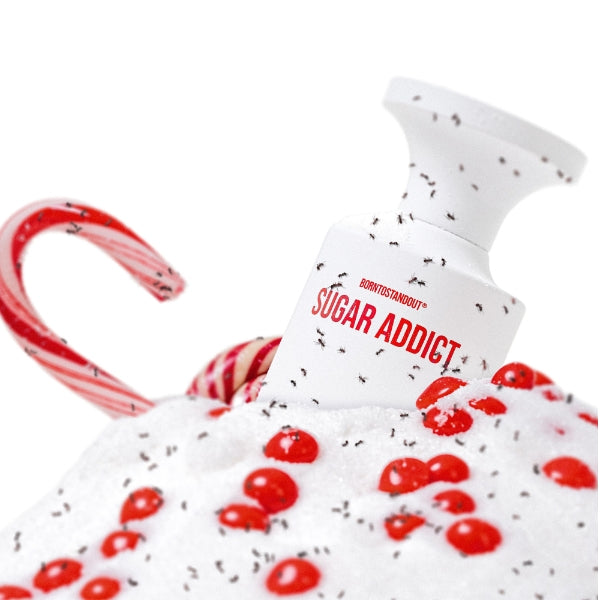 BORNTOSTANDOUT - Sugar Addict Flakon mit rotem Schriftzug auf süß dekorierter Oberfläche mit roten Perlen und Zuckerwatte