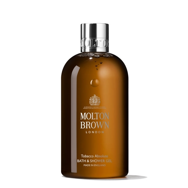 Molton Brown - Tobacco Absolute Bath & Shower Gel Flasche mit braunem Transparentglas und silbernem Verschluss vor weißem Hintergrund
