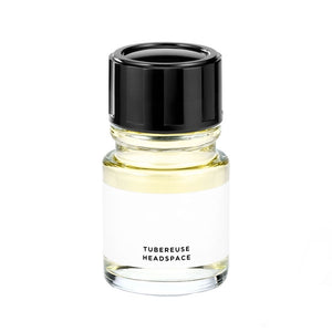 Headspace - Tubereuse Parfumflakon mit klarem Glas, schwarzem Deckel und schlichtem weißem Etikett auf weißem Hintergrund